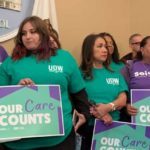 In-home care recipient Russell Rawlings, his caregiver Darrow Sprague and Kern County caregiver Sydney O'Connor stand with members of United Domestic Workers and SEIU Local 2015 at a press conference at the California State Capitol on Feb. 20, 2023.