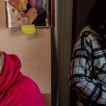 Maria Diaz, right, prepares medication for Luis Aguayo, 86, at his home in South Los Angeles. Diaz cares for Aguayo — who suffers from high blood pressure, severe arthritis and rheumatism, and who needs assistance walking — several times a week along with six other clients.