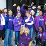 Sacramento IHSS workers holding fists and wearing purple